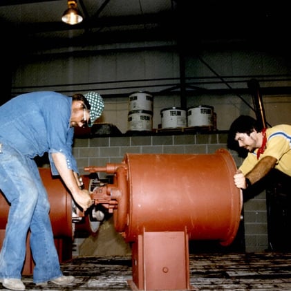 Workers adjusting equipment