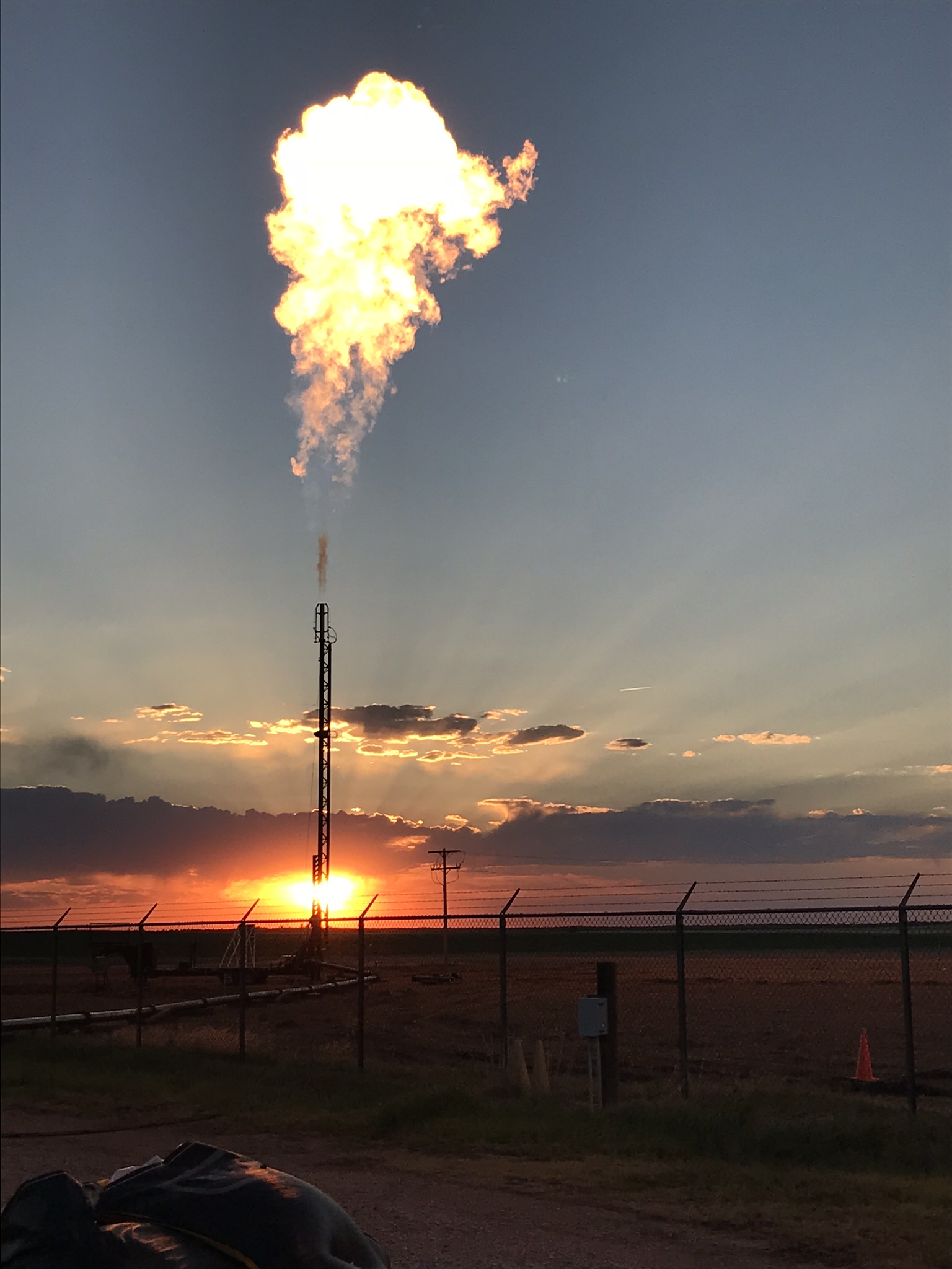 Wide shot of a flare firing in a pipeline blowdown operation