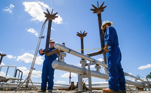 Workers inspecting ground flare system